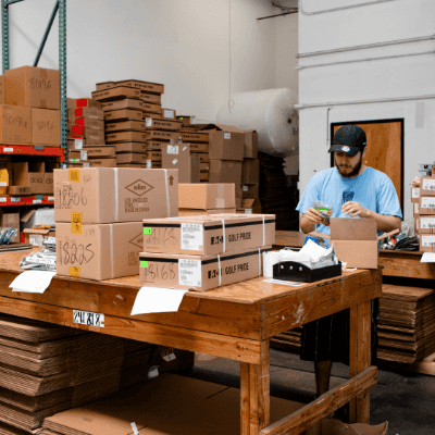 Warehouse worker boxing products to be shipped