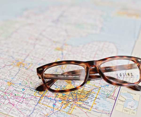 pair of reading glasses sitting on a map